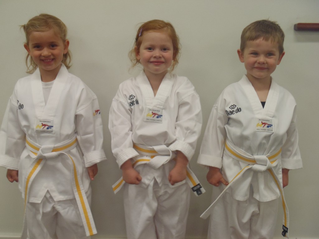 Abby Turner, Summer Marrapodi & Eric Buhlmann, proudly show the Yellow Dragonfly Belt they earned