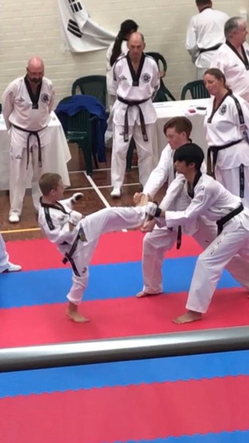 Deacon Malatesta smashes his boards during the Black belt grading - www.tkdcentral.com