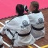 Maddison Booth & Mollie Swarbrick Await There Turn at Black Belt Grdaing - www.tkdcentral.com