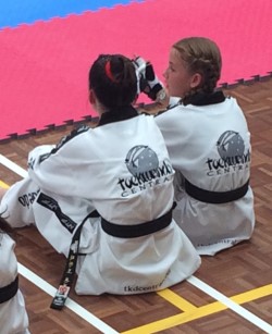 Maddison Booth & Mollie Swarbrick Await There Turn at Black Belt Grdaing - www.tkdcentral.com