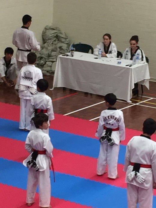 Matt Bowkley Gets Ready As Ajan watches at the grading table - www.tkdcentral.com