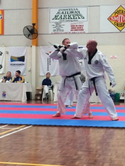 Travis Mackay performce an underarm Lock Defence against a knife attack