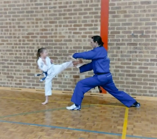 Annika Best concentrates the power of her kick to break a board - www.tkdcentral.com