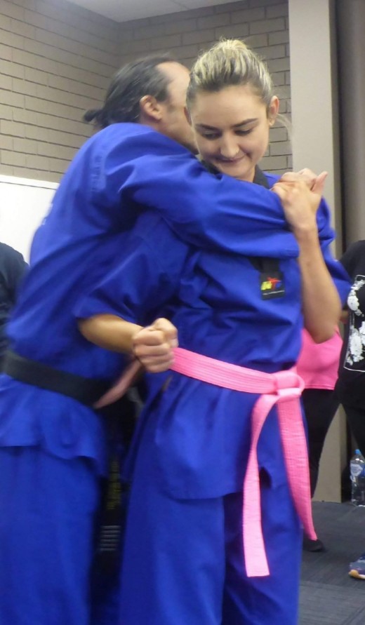 Ajana Plunkett demonstrates escaping a choke hold 1 - www.tkdcentral.com