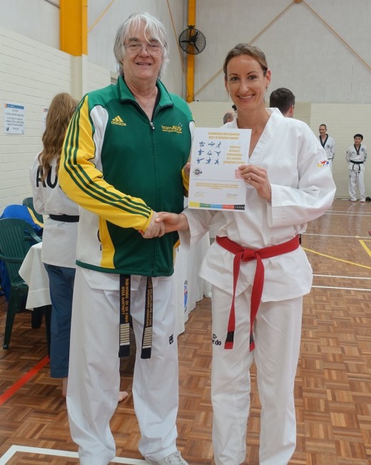 Grandmaster Ross Hartnett Gives Kelly Rowe Her Best Black Belt Grading Award - www.tkdcentral.com