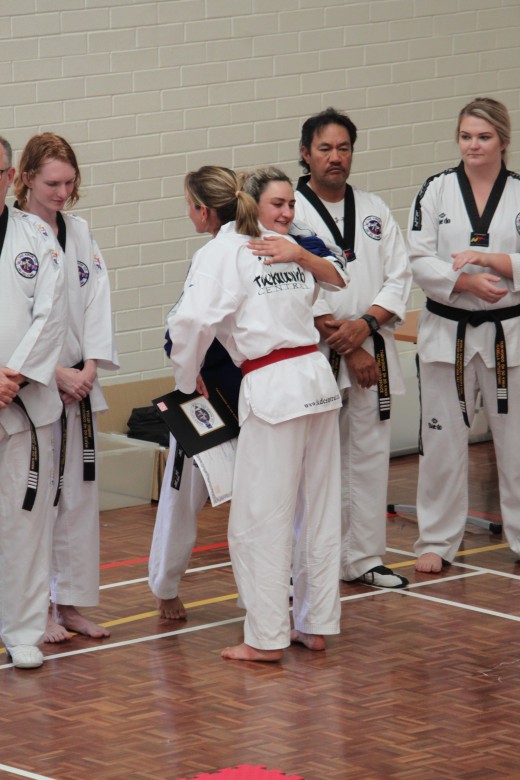 Head Instructor Ajana Plunkett Embraces New Black belt And Best Grading Award Winner Kelly Rowe - www.tkdcentral.com