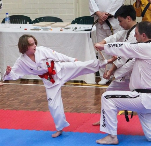 Lucas Hitchens Demonstrates A Beautiful Board Break At His 1st Dan Black Belt Grading - www.tkdcentral.com