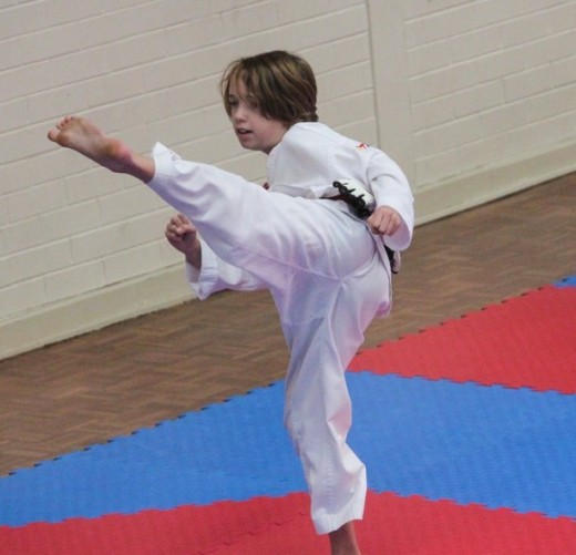 Lucas Hitchens Finishing Up A Soin Kick During His Black Belt Grading 2018 - www.tkdcentral.com