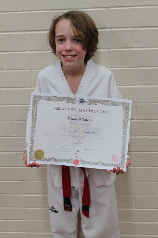 Lucas Hitchens Proudly Holds His 1st Dan Black Belt Certificate - www.tkdcentral.com