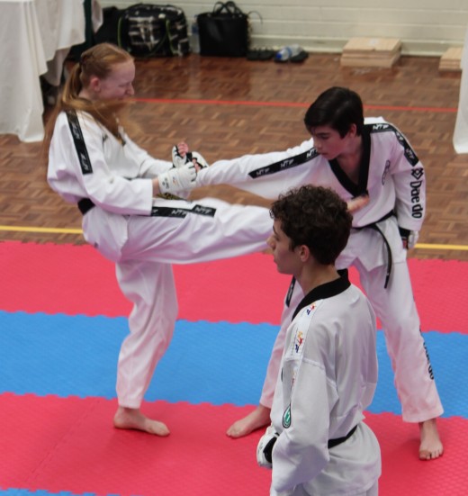 Trinity Best locks On A Straight Arm Wrist Lock Kick At Her 2nd Dan Black Belt Grading - www.tkdcentral.com